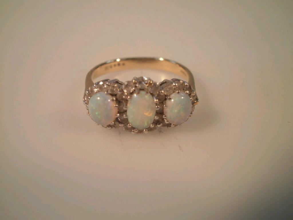 Appraisal: An opal and diamond set triple cluster ring shank stamped