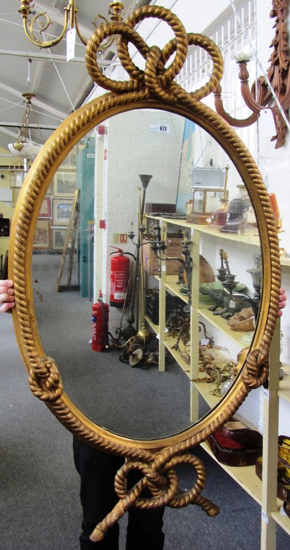 Appraisal: A th century gilt framed oval wall mirror with ropetwist