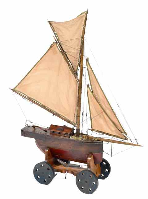 Appraisal: A MODEL OF A SINGLE MASTED SAILING BOAT on a