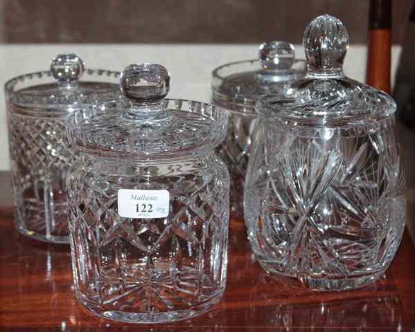 Appraisal: FOUR VARIOUS CUT GLASS JARS AND COVERS the largest high