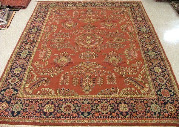 Appraisal: ORIENTAL INDO-SAROUK CARPET floral sprig motif across a rectangular red