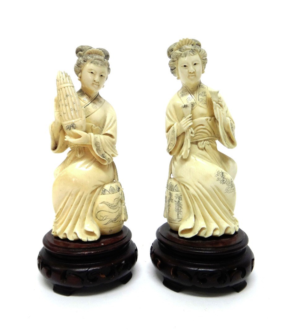 Appraisal: A pair of Chinese ivory figures of female musicians th