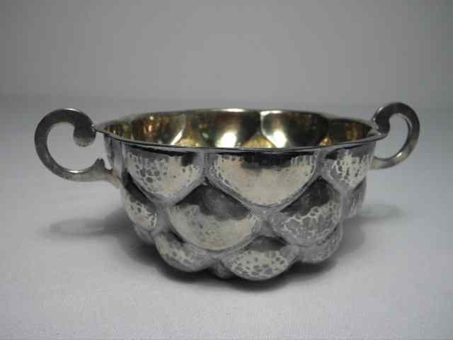 Appraisal: A Portuguese hand wrought sterling silver two handled cup Gold