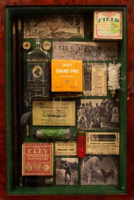 Appraisal: A wall hanging display case containing shooting ephemera to include