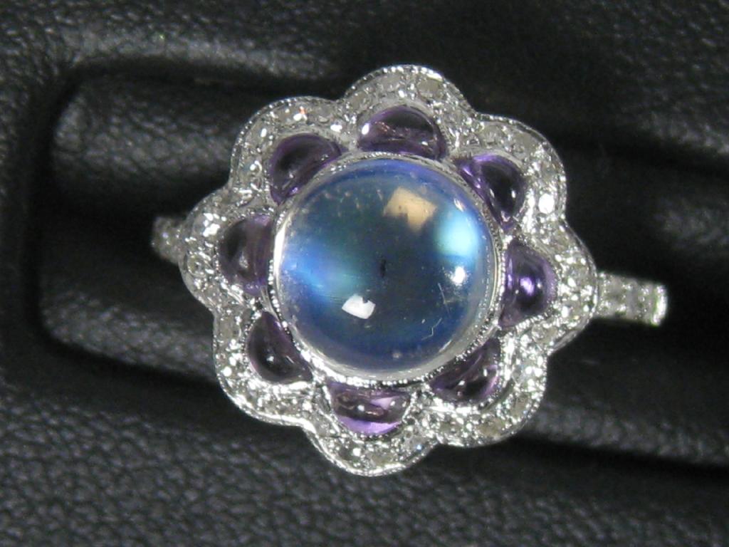 Appraisal: A Moonstone Amethyst and Diamond Ring the central cabochon moonstone