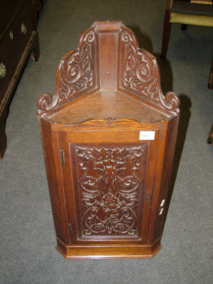 Appraisal: A foliate carved oak wall hanging corner cabinet together with