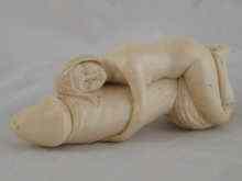 Appraisal: A very finely carved erotic ivory cane handle cm long