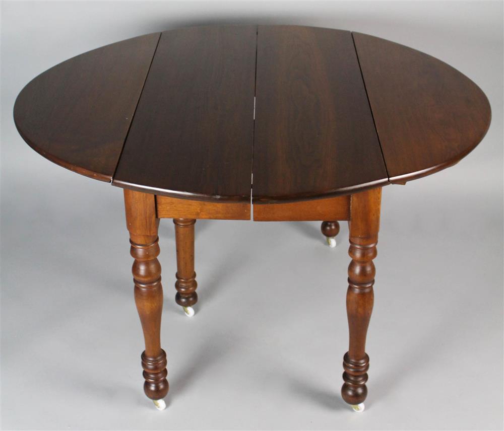 Appraisal: CIRCULAR WALNUT DROP LEAF DINING TABLE WITH TWO LEAVES with