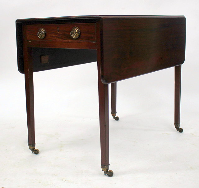 Appraisal: A MAHOGANY PEMBROKE TABLE with square tapering legs and brass