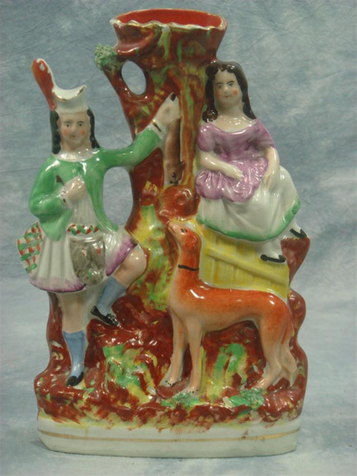 Appraisal: Staffordshire double figurine spill vase hunter with hanging game woman