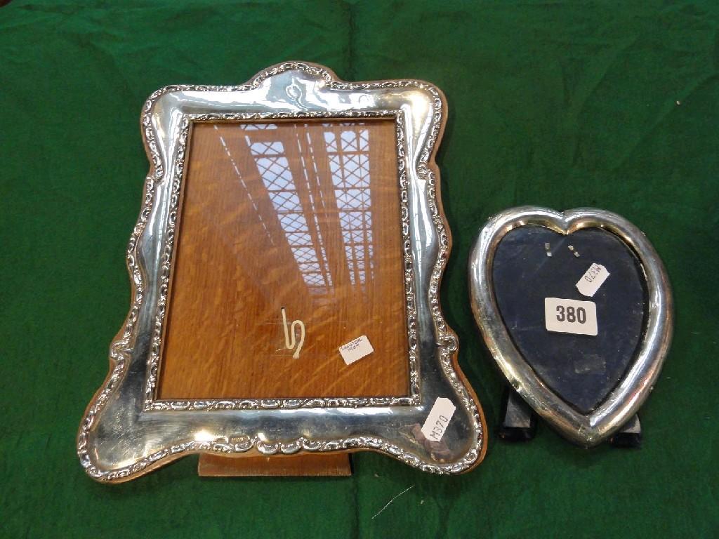 Appraisal: A silver photo frame with relief border Chester together with