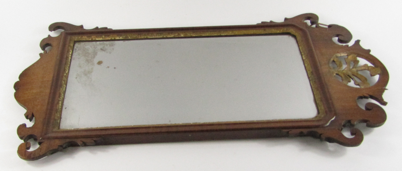 Appraisal: A George III mahogany fret work wall mirror inset bevelled