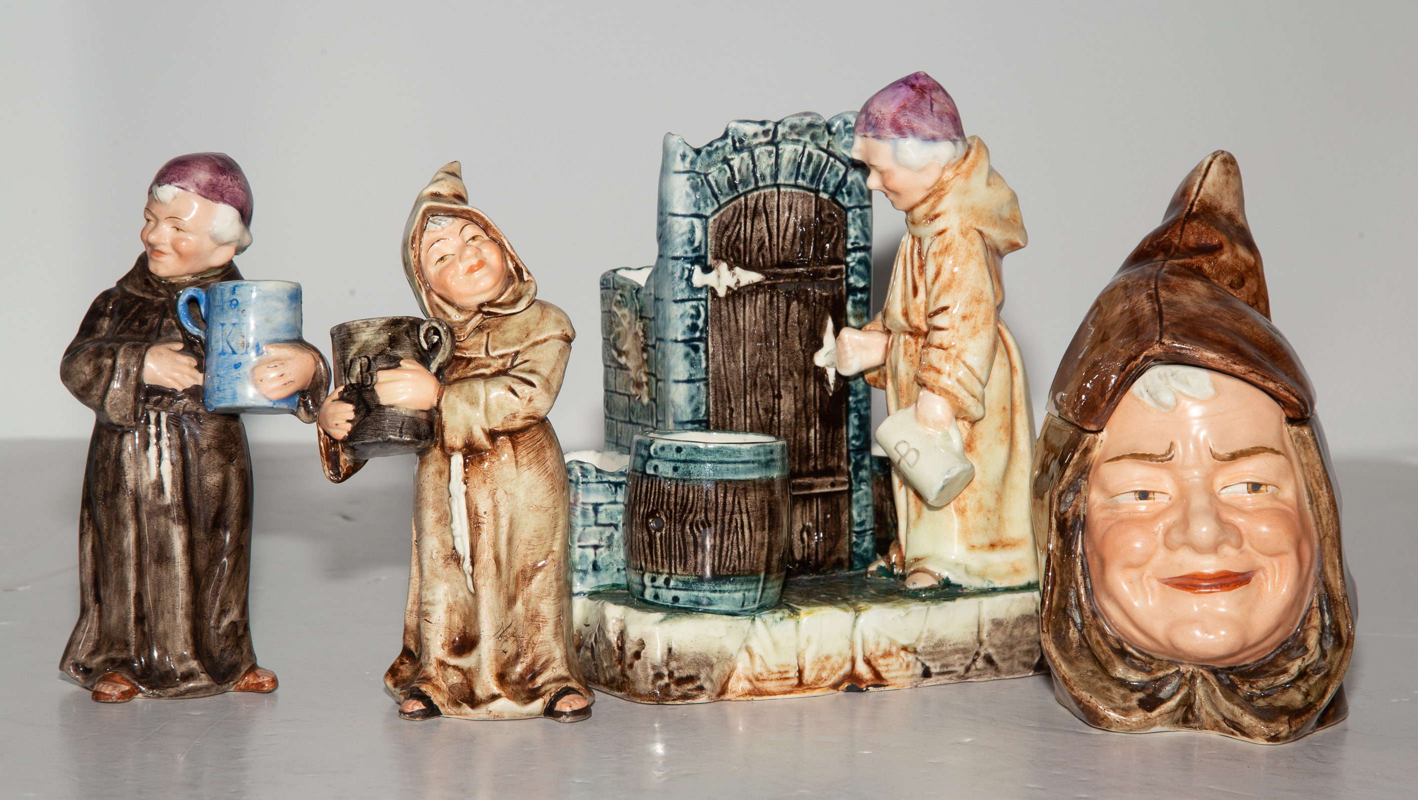 Appraisal: FOUR MONK-THEMED CERAMIC FIGURES Austrian circa including a smoker's caddy