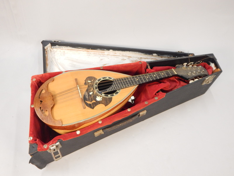 Appraisal: A Neapolitan mandolin with ebonised handle etc unmarked in a