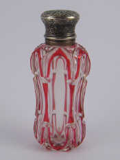 Appraisal: A Victorian ruby flashed carved cut glass perfume bottle unmarked