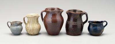 Appraisal: Five pottery pitchers one with brown Albany slip glaze stamped