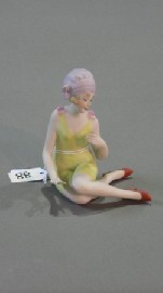 Appraisal: A bisque figure of a bathing beauty wearing a green