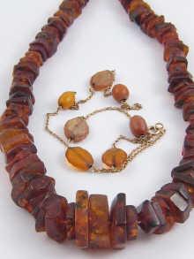 Appraisal: An unpolished amber necklace together with a yellow metal chain