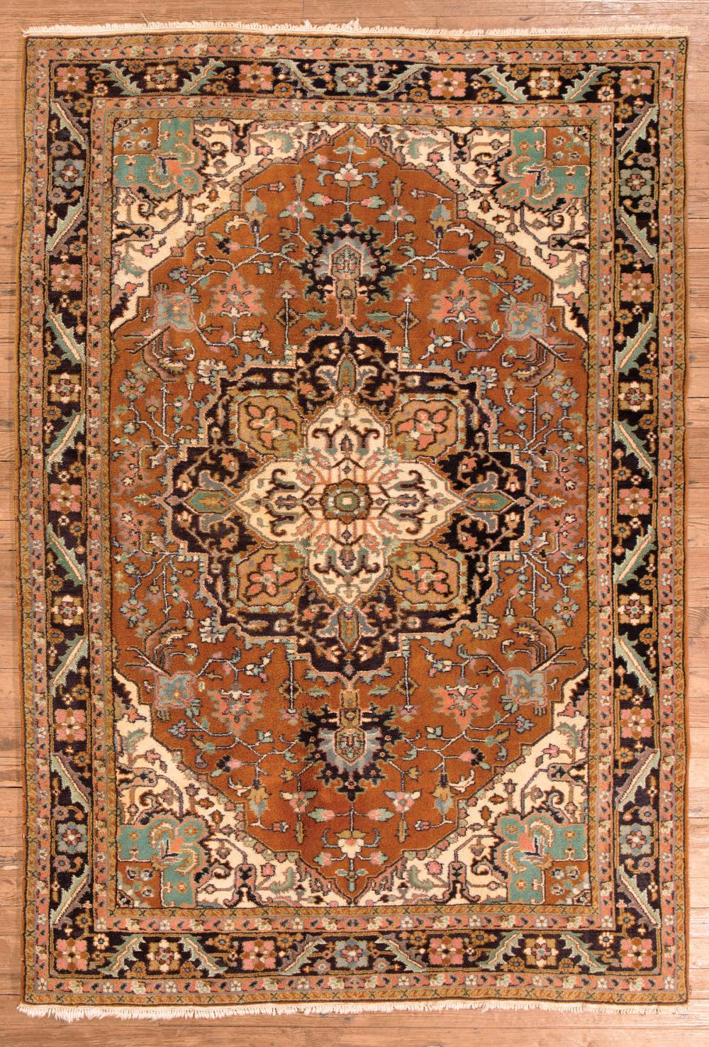 Appraisal: Kirman Carpet rust and cream ground central medallion stylized floral