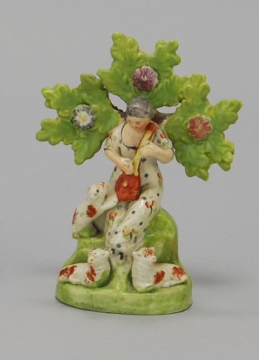 Appraisal: STAFFORDSHIRE FIGURE GROUP Circa In the form of a girl