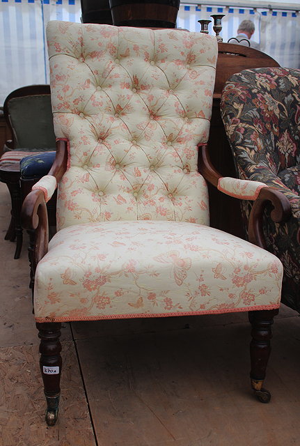 Appraisal: A VICTORIAN MAHOGANY FRAMED BUTTON UPHOLSTERED OPEN ARMCHAIR with folding