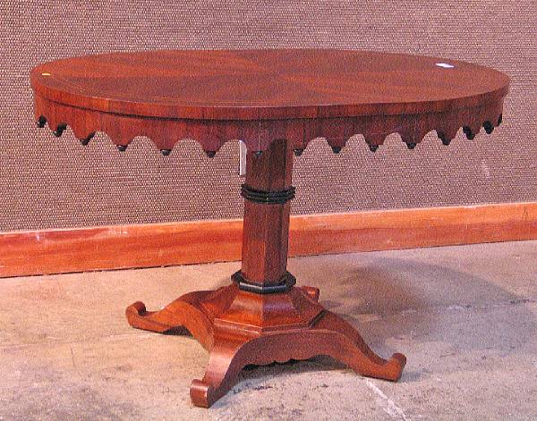 Appraisal: A Gothic Revival style parcel ebonized mahogany center table modern