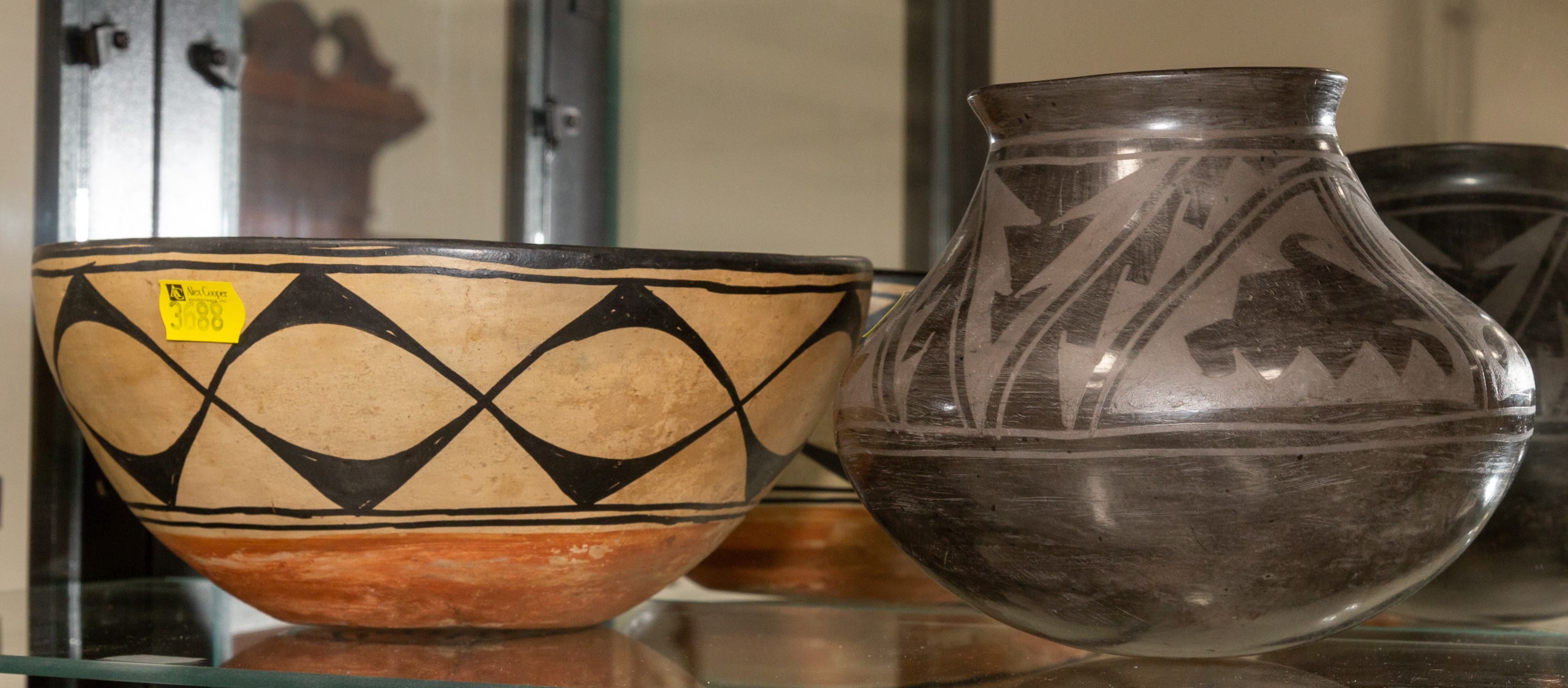 Appraisal: TWO SOUTHWESTERN CERAMIC ITEMS Comprising a burnished black earthenware jar