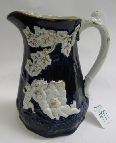 Appraisal: ENGLISH GLAZED POTTERY PITCHER c having raised cherubs and leaves