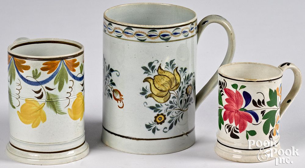 Appraisal: Three pearlware mugs th c with floral decorat Three pearlware