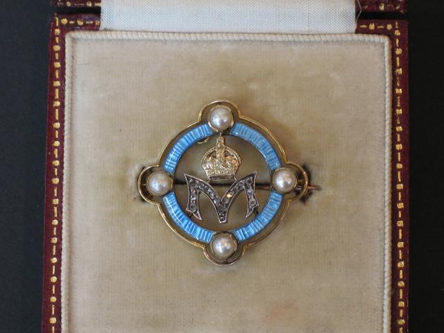 Appraisal: A BLUE ENAMEL AND PEARL BROOCH the open circle design