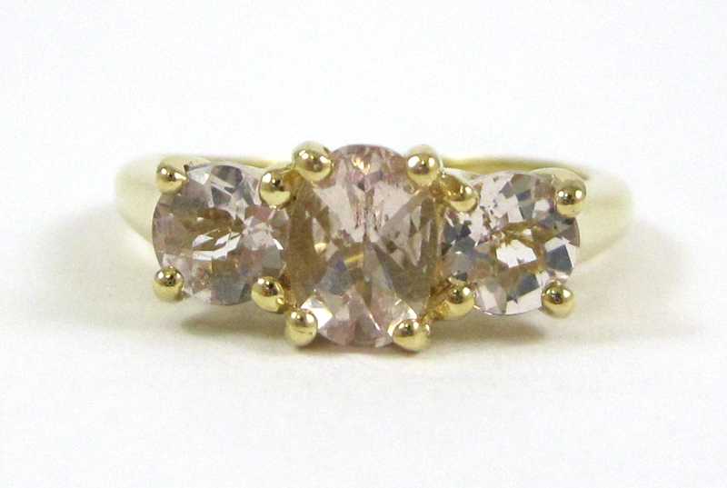 Appraisal: PINK GEMSTONE AND FOURTEEN KARAT GOLD RING set with three