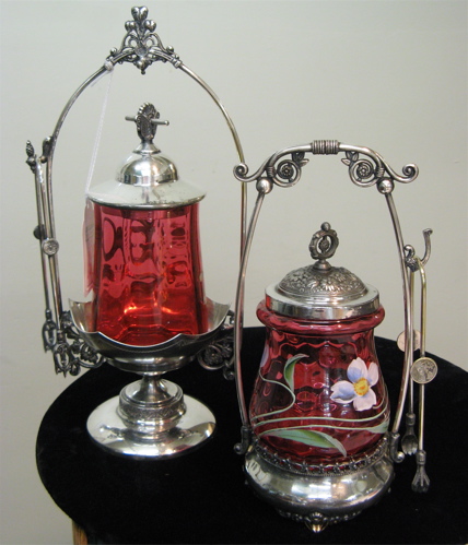 Appraisal: TWO AMERICAN VICTORIAN PICKLE CASTORS One in a ruby enameled