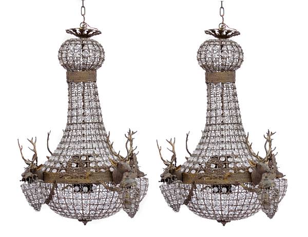 Appraisal: A pair of Neoclassical style crystal chandeliers with figural stag