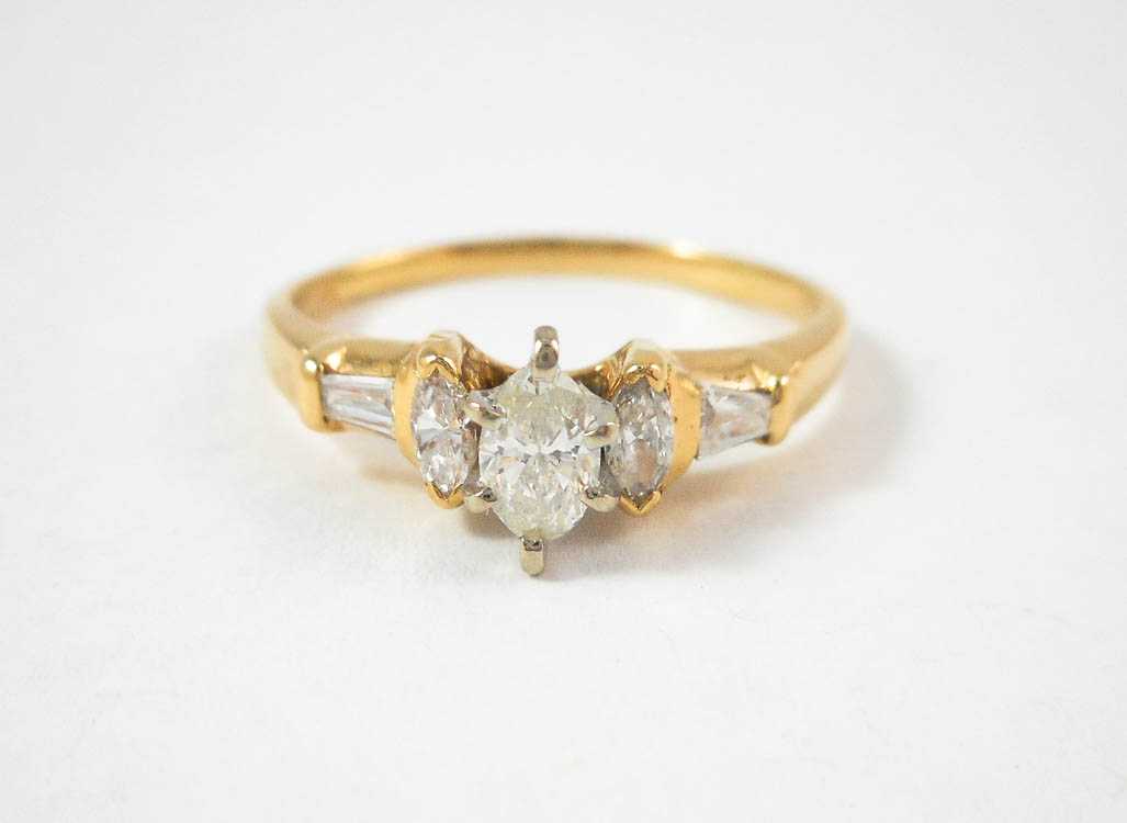 Appraisal: DIAMOND AND FOURTEEN KARAT GOLD RING with two marquise-cut and