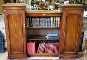 Appraisal: Victorian mahogany open bookcase flanked by full height arched panel