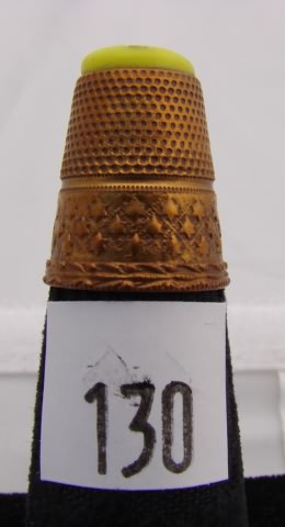 Appraisal: Copper tone yellow tip with gold butterfly design thimble