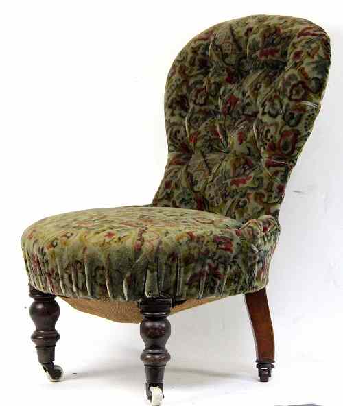 Appraisal: A Victorian upholstered nursing chair with shaped button back on