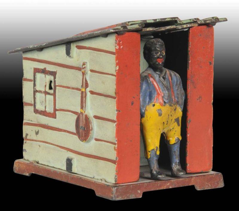 Appraisal: Cast Iron Cabin Mechanical Bank Description Manufactured by J E