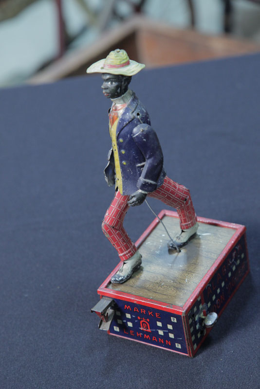 Appraisal: ALABAMA COON JIGGER TOY Tin lithographed mechanical toy marked ''Alabama