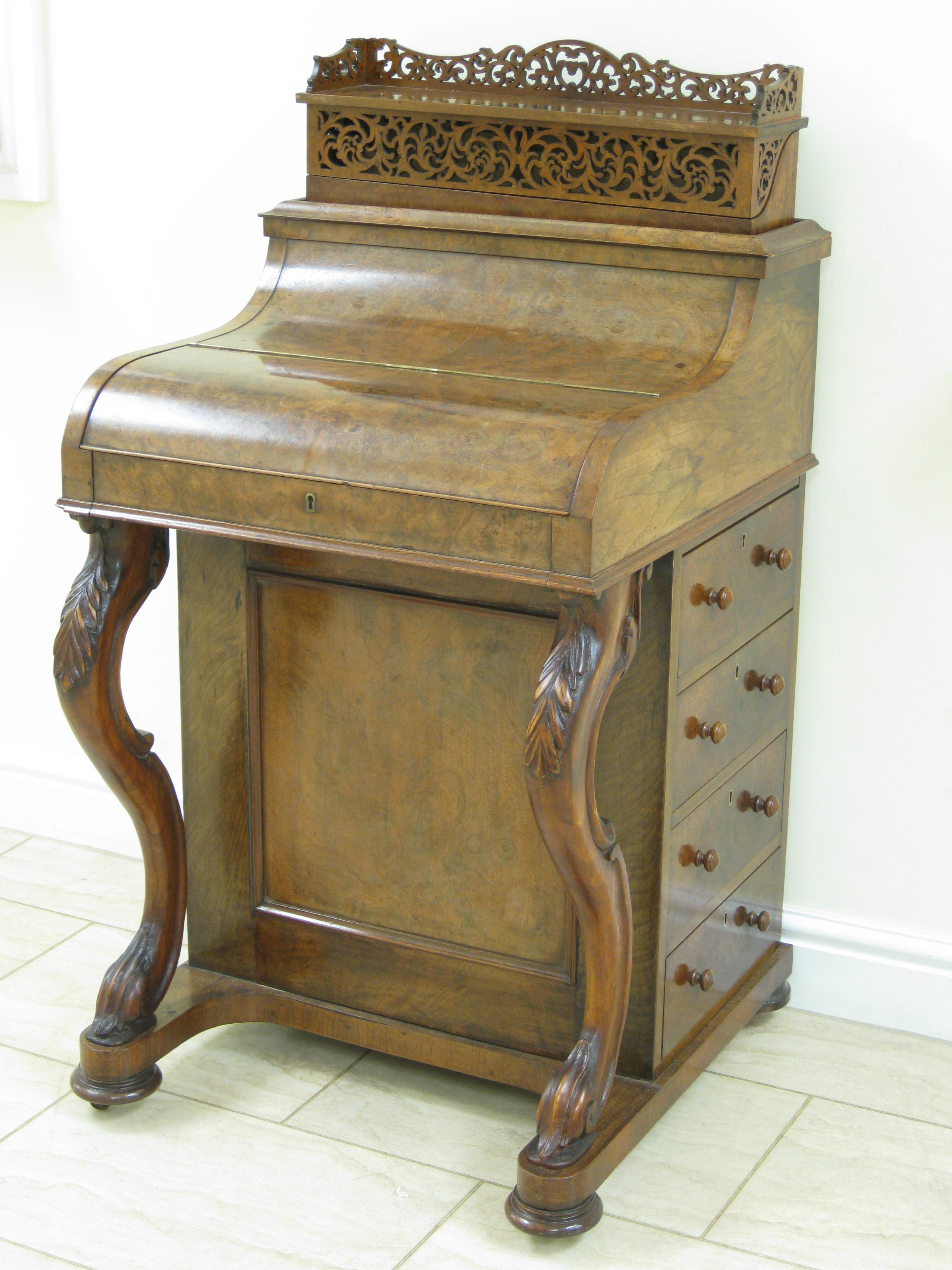 Appraisal: A Victorian burr walnut piano top Davenport with pop-up stationary