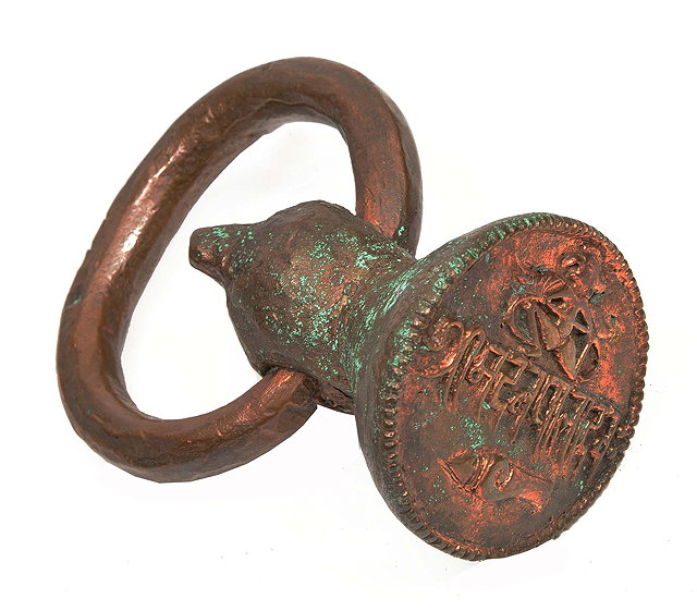 Appraisal: A possibly Persian copper seal with looped handle cm tall