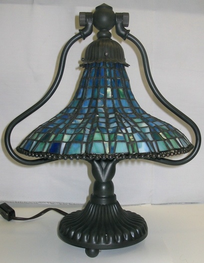 Appraisal: A STAINED AND LEADED GLASS DESK LAMP in the manner