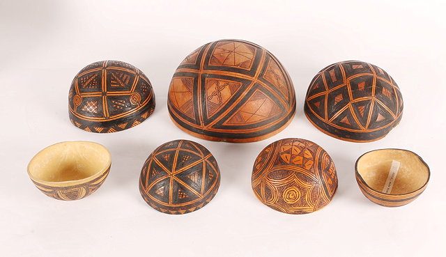 Appraisal: SEVEN NIGERIAN SMALL CALABASHES with stylised geometric and painted decoration