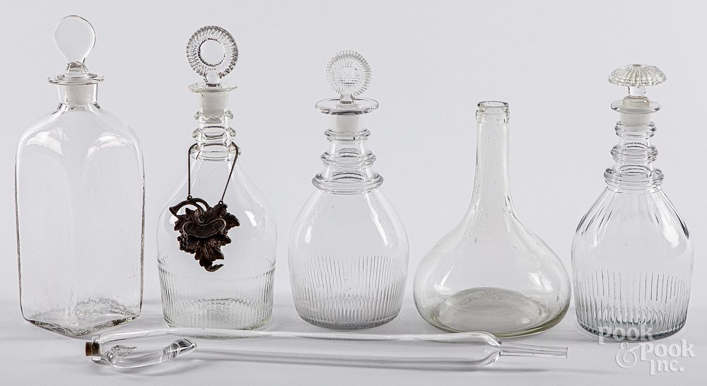 Appraisal: Five colorless glass decanters and wine taster Five colorless glass