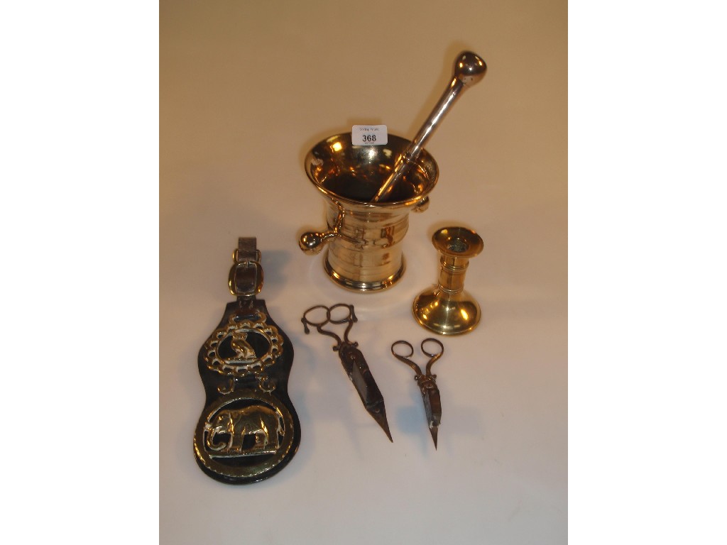 Appraisal: A Bell metal pestle and mortar a brass candlestick two