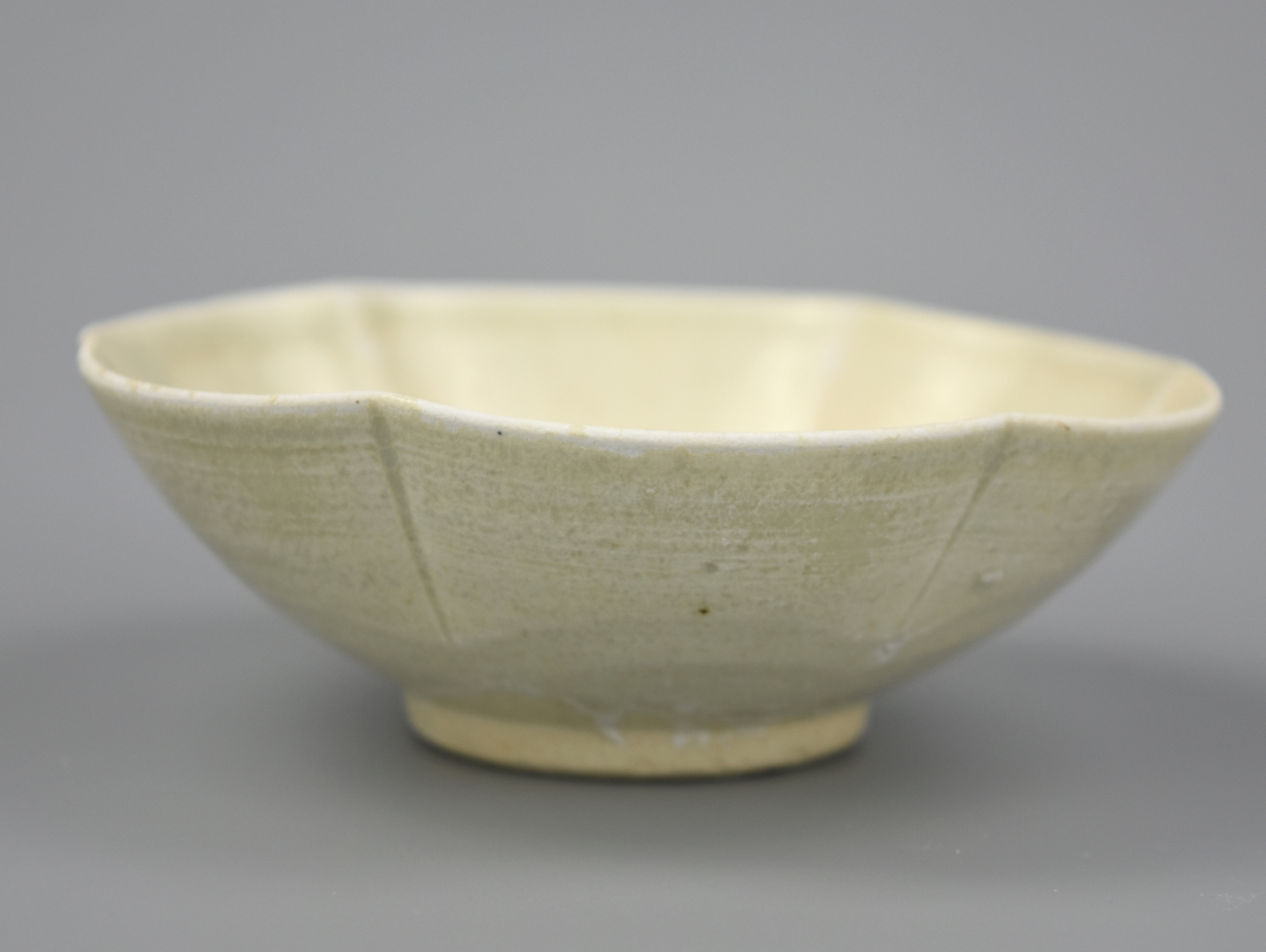 Appraisal: A LOBED CHINESE WHITE GLAZED CUP SONG DYNASTY A Chinese