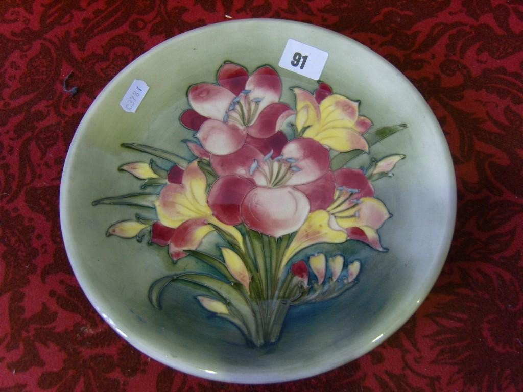 Appraisal: A green ground Moorcroft plate of circular form with painted