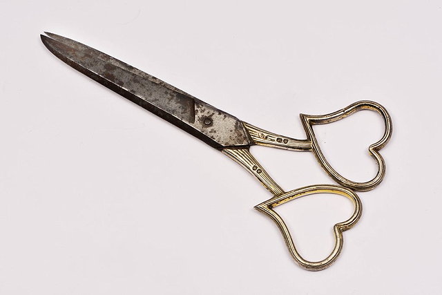 Appraisal: A PAIR OF SCISSORS with silver handles with double heart