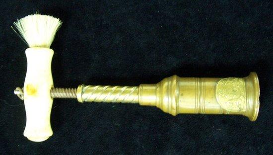 Appraisal: A brass double action corkscrew with turned ivory handle and