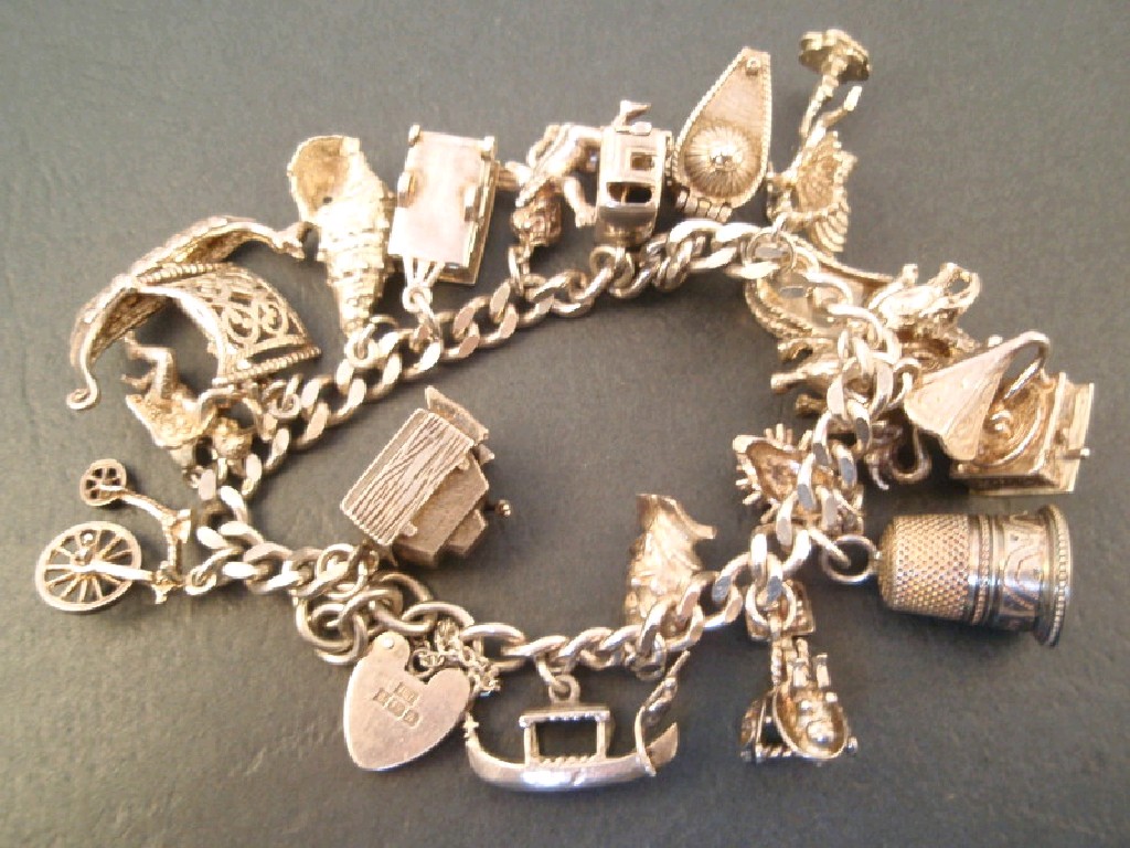 Appraisal: A silver charm bracelet with twenty charms